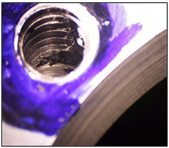 Fig. 2. (a) Deep seated shrinkage in the square end face tapped holes, (b) Shrinkage area from another angle showing damaged threads, (c) Large scale shrinkage in the thickest sections- Al cut piece.