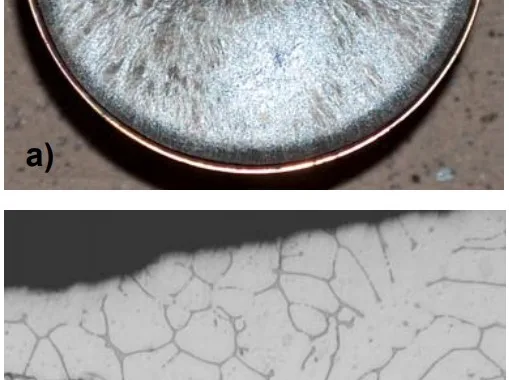 Figure 1. a) Photograph of the as-solidified top surface of a sample of AM-HP2 cast in air and b) an optical photomicrograph near the ‘free’ surface of a section through the diameter of the casting shown in (a) and showing a very limited extent of oxidation.