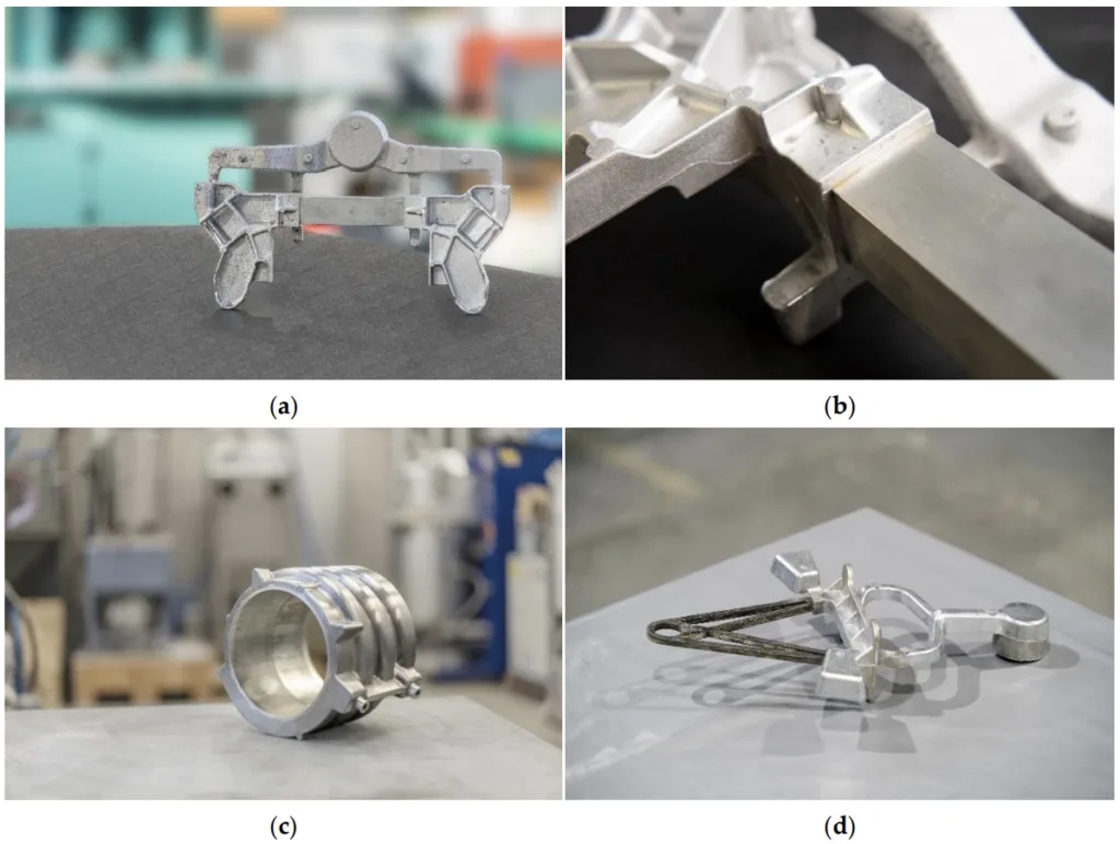 Figure 6. Sample images of parts produced by compound (a–c) and hybrid casting (d); (a,b) AlSi7Mg0.3 LPDC subsize front axle carrier frame demonstrator with integrated EN AW6060 extrusion, general (a) and detail view (b); (c) AlSi9Cu3 HPDC e-motor housing demonstrator with integrated aluminum tubes as cooling channels, cast by ae group AG, Gerstungen, Germany; (d) aerospace secondary structure hybrid bracket combining a CFRP and an aluminum HPDC component [131] (all images by Fraunhofer IFAM)