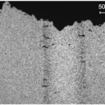 Figure 7. Cracks initiated in the pore bands of a tensile bar during tension, alloy AM60B.