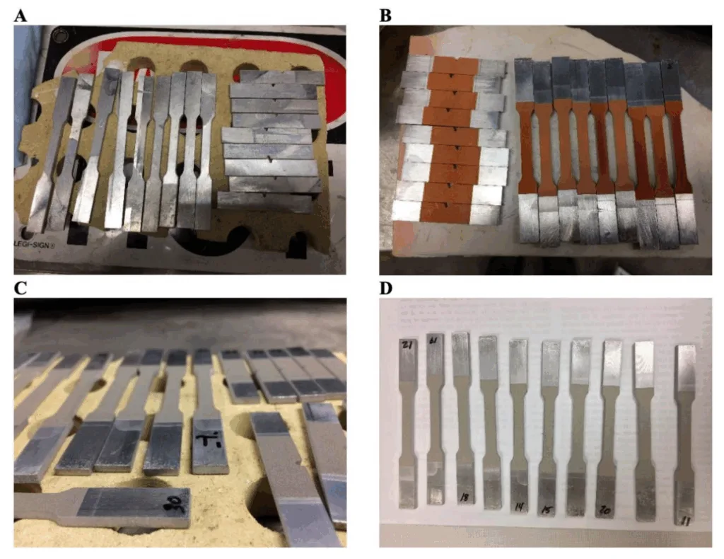 Figure 1. (A) Digital image of the waterjet cut HPDC A365 substrate/base material as reference specimens that therefore did not undergo cold gas dynamic spray (CGDS) processing. (B) Digital photo of the thinly coated and Cu CGDS processed A365 HPDC substrate specimens. (C,D) Digital images are similar to (B), where Ni and Ti were utilized as feedstock, respectively. For reference, the thickness of the base material (see (C) with the properly oriented specimen labeled “30”) was 2.5 mm before CGDS processing or postprocessing after that. Solution treatments we